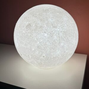 Side view of the 3D printed moon night light with bright LED light.