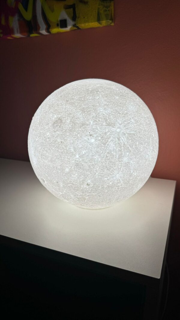 Side view of the 3D printed moon night light with bright LED light.