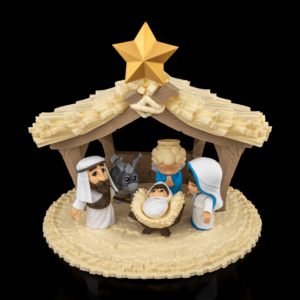 A 3D-printed nativity scene featuring baby Jesus, Mary, Joseph, and additional characters under a detailed stable with a star on top.