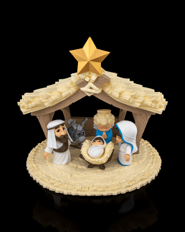 A 3D-printed nativity scene featuring baby Jesus, Mary, Joseph, and additional characters under a detailed stable with a star on top.