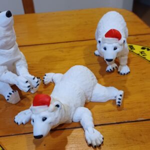 3 White flexi polar bears with Santa hats on in various poses.