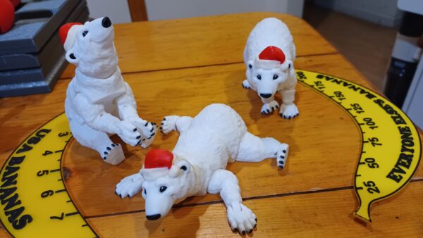 3 White flexi polar bears with Santa hats on in various poses.